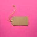 AI-Generated Light Brown Tag with String Loop on Pink Surface Royalty Free Stock Photo