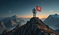 A man stands on a mountain top holding a flag with a red cross on it.