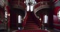 Ai generated luxurious red staircase with elegant chandelier and carpet