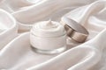 Open Luxury Face Cream Jar Displayed On Flowing Silk Fabric Royalty Free Stock Photo