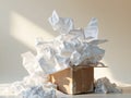 Overflowing crumpled white wrapping paper in cardboard box on beige background Royalty Free Stock Photo