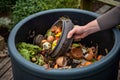 AI generated person scooping out food waste from a compost pile