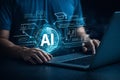 AI generated person typing on laptop with glowing ai globe interface and education icons representing digital learning online Royalty Free Stock Photo