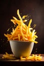 French fries falling into a bowl with cheese sauce