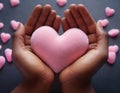 AI generated pink plush heart in hands. Soft light. Cozy photo