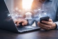 AI generated professional using laptop and smartphone with digital banking interface showing secure payments financial services Royalty Free Stock Photo