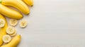 AI-generated Ripe Bananas Sliced and Whole on White Plank Table Royalty Free Stock Photo