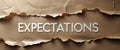 Ripped brown paper backdrop featuring the word Expectations Royalty Free Stock Photo