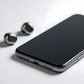 AI-Generated Smartphone and Two Wireless Earbuds on a White Surface Royalty Free Stock Photo
