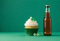 st patrick\'s day cupcake and beer on green background Royalty Free Stock Photo