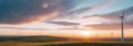 a sunset over a wind farm with windmils Royalty Free Stock Photo