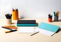 a table with a notebook, pencils, and pens Royalty Free Stock Photo