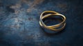 Three interlocking bands form an elegant ring on a textured dark surface