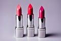 Three lipsticks are lined up on a table Royalty Free Stock Photo