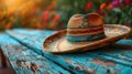 Traditional Mexican sombrero on a weathered blue wooden surface.