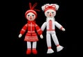 two martenitsa dolls in red and white clothing