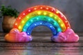 Vibrant illuminated rainbow arch with pink cloud bases on a reflective surface, creating a playful and colorful look, perfect f