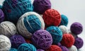 A pile of yarn balls in various colors, including blue, red, and white.