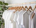 AI generated White t-shirts on hangers in modern room, closeup Royalty Free Stock Photo