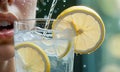 AI generated Young girl drinks water with ice and lemon from a glass