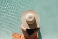 AI GENERATIVE, beautiful woman in a hat sitting on the edge of the swimming pool