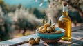 Bowl of green olives and a bottle of olive oil on a table with a bokeh background. Royalty Free Stock Photo