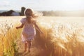 Ai generative. Happy blonde girl child running across the field outdoors