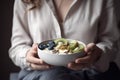 AI GENERATIVE, Healthy breakfast, Woman holds a bowl with a healthy breakfast of yogurt and fruit, with oat flakes Royalty Free Stock Photo