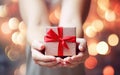 Ai generative. Christmas gift box with red ribbons in female hands Royalty Free Stock Photo