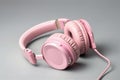 Ai Generative Pink headphones on a gray background. The concept of music and technology