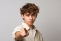 Ai Generative Portrait of handsome young man pointing finger at camera and looking at camera with serious expression