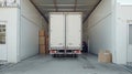 Rear view of a delivery truck at a loading dock with boxes outside. Royalty Free Stock Photo