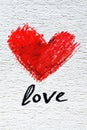 Red heart drawn with crayon on textured paper with Love written below. Royalty Free Stock Photo