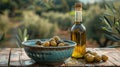 Rustic bowl of olives with a bottle of olive oil on a wooden table outdoors. Royalty Free Stock Photo