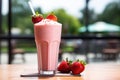 Ai generative. Strawberry milkshake in a glass with a straw