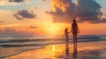 Sunset silhouette of mother and child walking on the beach. Royalty Free Stock Photo