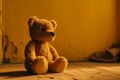 Ai Generative Teddy bear sitting on the floor in front of a yellow wall