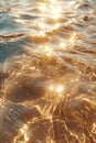 Water surface bathed in golden sunlight, with vibrant sparkles and ripples. Royalty Free Stock Photo