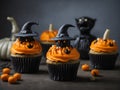An AI illustration of a group of cupcakes with orange frosting and witches hats