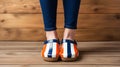 An AI illustration of the legs and toes of a person wearing striped shoes, on a wood floor