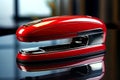 An AI illustration of a red stapler laying on top of a black counter Royalty Free Stock Photo