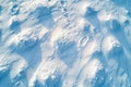 AI image aerial view of fresh snow dunes with sunlight creating patterns textures winter background Royalty Free Stock Photo