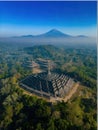 AI image Ancient Borobudur temple nestled in lush greenery with mountain backdrop Java Indonesia Royalty Free Stock Photo