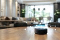 AI-powered virtual assistant device at living room area, ready to control smart device at home