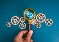 AI searching tools, development and management technology assistance service support concept. Bot icon in magnifying glass lens in