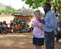 Aid relief volunteer emotional crying in face of poverty village Africa Royalty Free Stock Photo