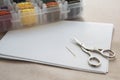 Aida white canvas, needle, needlework scissors and a box with multicolored embroidery threads, needlework Royalty Free Stock Photo