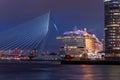 Aidaperla cruise ship and Erasmus bridge illuminated at night in Rotterdam Royalty Free Stock Photo