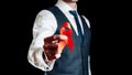 Aids awareness. Red ribbon symbol in hiv world day in man hand isolated on dark background. Awareness aids and cancer Royalty Free Stock Photo