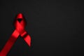 Aids day. Red ribbon symbol in hiv world day on dark background. Awareness aids and cancer. Healthcare and medical concept Royalty Free Stock Photo